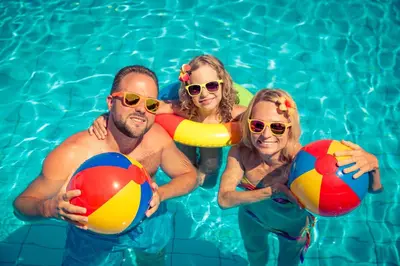 a group of people in a swimming pool holding beach balls at 6 Berth Caravan For Hire At Seawick Holiday Park By The Beach Ref 27431Sw in Clacton-on-Sea