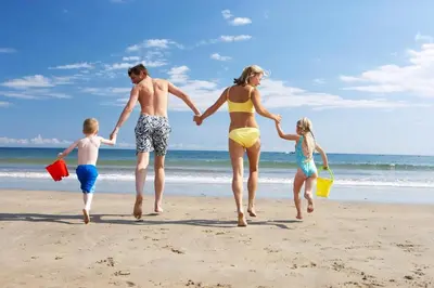 a family running on the beach at 6 Berth Caravan For Hire At Seawick Holiday Park By The Beach Ref 27431Sw in Clacton-on-Sea