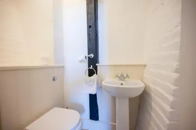 a white bathroom with a toilet and a sink at Wool Room, Merchant House, Ipswich in Ipswich
