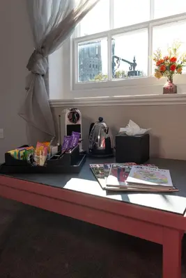 a table with books and a window in a room at Poets 24 in Ely