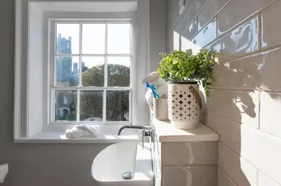 a bathroom with a sink and a window at Poets 24 in Ely