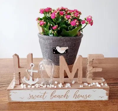 a sign for a sweet beach house with a potted plant at Beachside Terrace in Dovercourt