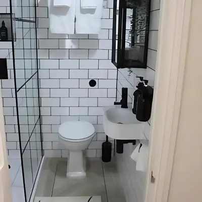 a white bathroom with a toilet and a sink at Stunning house in the heart of Leigh-On-Sea in Leigh-on-Sea