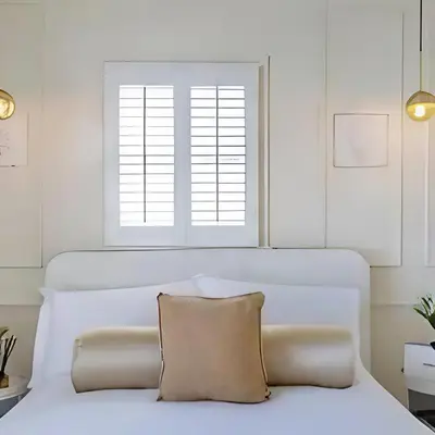 a white bedroom with a white bed with a window at Stunning house in the heart of Leigh-On-Sea in Leigh-on-Sea