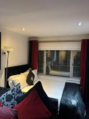 a bedroom with a bed and a window at Amazing studio room in a beautiful house in Stanford le Hope