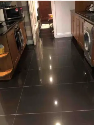 a kitchen with a black tiled floor with a washer at Amazing studio room in a beautiful house in Stanford le Hope