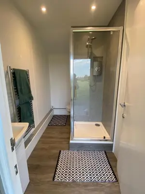 a bathroom with a shower and a sink at Farmview Bell Tent in Messing