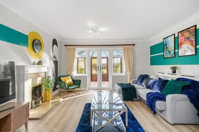 a living room with a couch and a fireplace at Detached 6 Bedroom Cambridgeshire Abode - Pets in Whittlesford