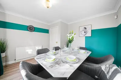 a dining room with a table and chairs at Detached 6 Bedroom Cambridgeshire Abode - Pets in Whittlesford