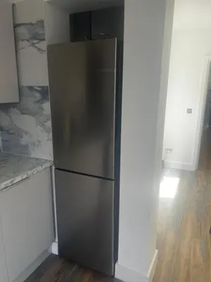 a stainless steel refrigerator in a kitchen at Southend Luxe Retreat in Southend-on-Sea