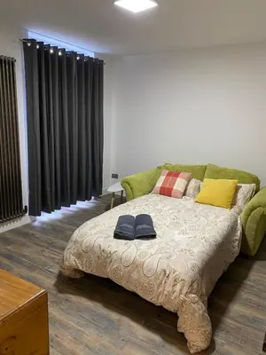 a bedroom with a bed with two hats on it at Southend Luxe Retreat in Southend-on-Sea