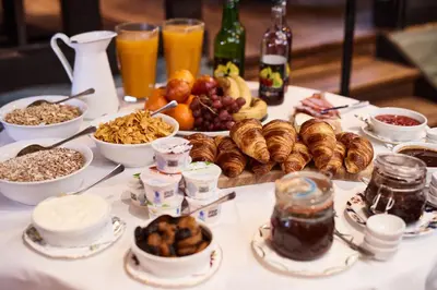 a table with breakfast foods and drinks on it at The Sun Inn in Dedham