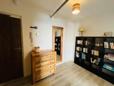 a room with a wooden dresser and a book shelf at 503 Focus Apartments in Ipswich