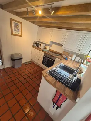 an overhead view of a kitchen with a sink at Lime Kiln Quay Cottage in Woodbridge