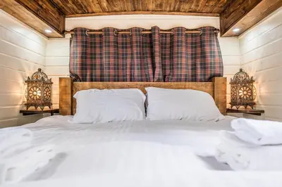 a bedroom with a bed with white sheets and pillows at The Bus Stop, Thornham Magna in Thornham Magna