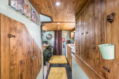 a kitchen with wooden walls and a wooden ceiling at The Bus Stop, Thornham Magna in Thornham Magna