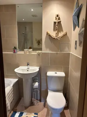 a bathroom with a toilet and a sink at Cosy central hideout in Ware