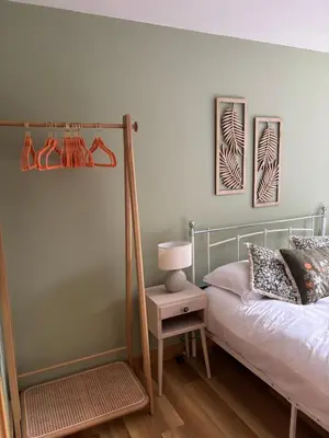 a bedroom with a bed and a lamp on a table at Cosy central hideout in Ware