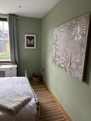 a bedroom with a bed and a painting on the wall at Cosy central hideout in Ware