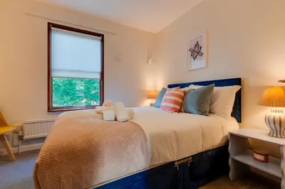 a bedroom with a large bed with a window at Modern and Stylish Townhouse in City Centre Pass the Keys in Cambridge