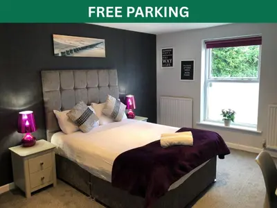 a bedroom with a bed with two lamps and a window at OYO Watton Vibe Hotel in Watton