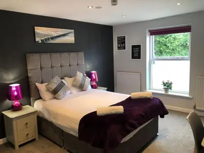 a bedroom with a large bed and a window at OYO Watton Vibe Hotel in Watton