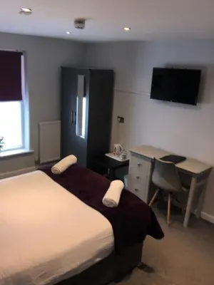 a hotel room with a bed and a desk and a desk at OYO Watton Vibe Hotel in Watton