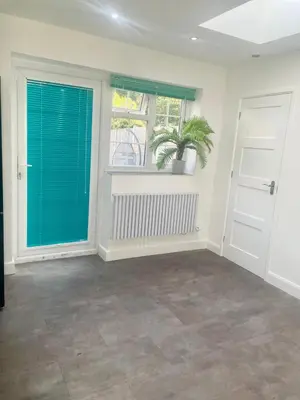 a room with doors and a plant in a window at Relaxed Leigh-on-Sea Escape, Family-Friendly & Contractor Stays in Hockley