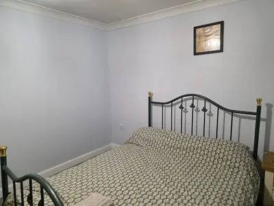 a bed in a bedroom with a picture on the wall at Stay Near Colchester twn centre2 in Colchester