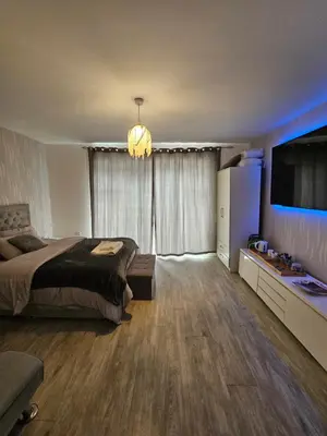 a bedroom with a bed and a television in a room at Bright spacious room in Manningtree in Manningtree