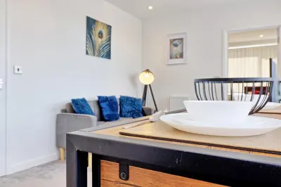 a table with a white bowl on top of it at Cozy 1 Bed Flat Corringham-Essex in Fobbing