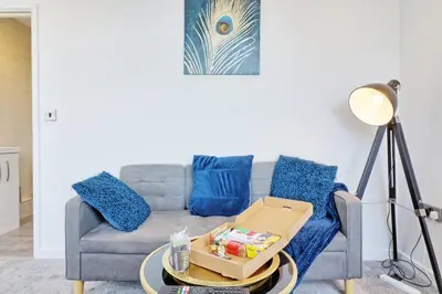 a living room with a couch with a box on a table at Cozy 1 Bed Flat Corringham-Essex in Fobbing