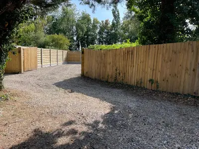 a wooden fence next to a wooden fenceasteryasteryasteryasteryasteryasteryasteryastery at Highgate Cabin in Takeley