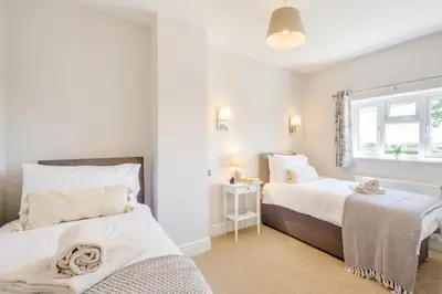 a bedroom with two beds and a window at 3 Bed in Little Clacton oc-l32526 in Little Clacton