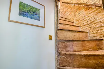 a wooden door in a room with a picture on the wall at 4 Bed in St. Nicholas South Elmham oc-o32397 in Saint Margaret