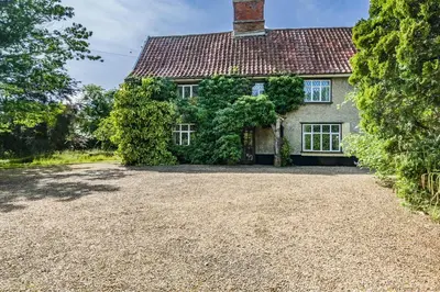 an image of a house with a gravel driveway at 4 Bed in St. Nicholas South Elmham oc-o32397 in Saint Margaret