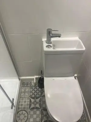 a bathroom with a white toilet and a sink at High street in Toft