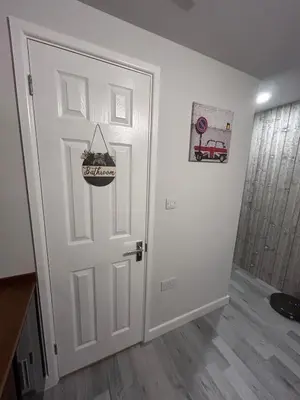 a room with a door with a basket on it at Somewhere Nice & Cozy in Little Clacton