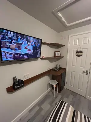 a living room with a flat screen tv on the wall at Somewhere Nice & Cozy in Little Clacton