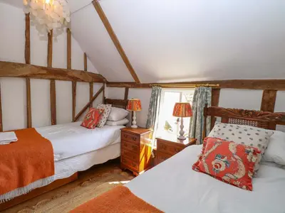 a bedroom with two beds and a window at Bank House in Norwich