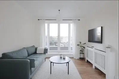 a living room with a couch and a table at Amazing Abodes in Chelmsford