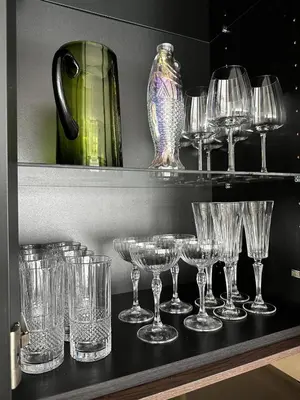 a bunch of glasses sitting on a shelf at Canewdon Rd Luxury Accommodation in Westcliff On Sea
