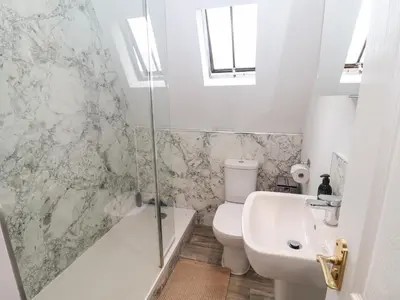 a bathroom with a toilet and a sink and a shower at Old Felixstowe, Bath Road in Felixstowe