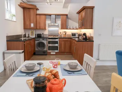 a kitchen with a table with food on it at Old Felixstowe, Bath Road in Felixstowe