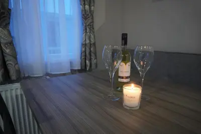 a bottle of wine and two wine glasses on a table at Neptune in Parkeston