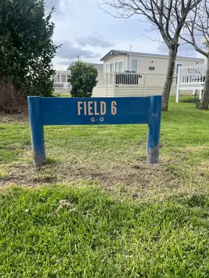 a blue sign in the grass in a yard at Neptune in Parkeston