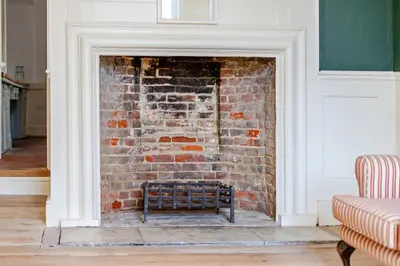 a brick fireplace with a chair in front of it at 6 Angel Hill, Bury st Edmunds in Bury Saint Edmunds