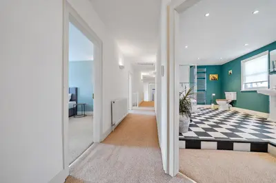 a living room with a checkered floor and a hallway at 6 Angel Hill, Bury st Edmunds in Bury Saint Edmunds