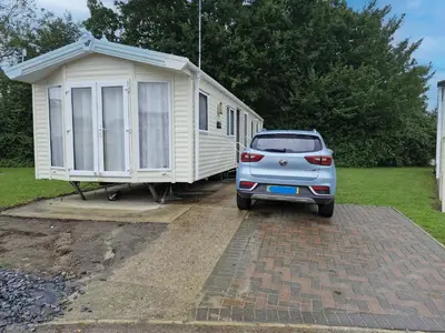 a car parked in front of a tiny house at Lovely Caravan At Carlton Meres Holiday Park Ref 60034O in Saxmundham