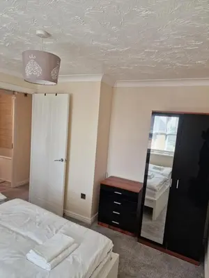a bedroom with a mirror and a bed and a dresser at SK Short Let